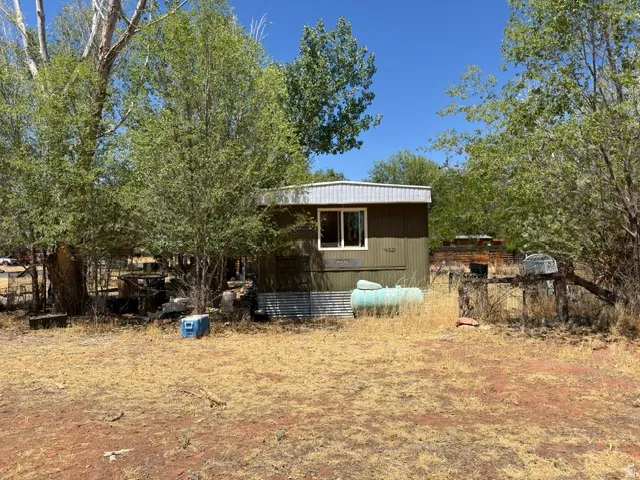 Single-story structure featuring a metal roof and horizontal siding