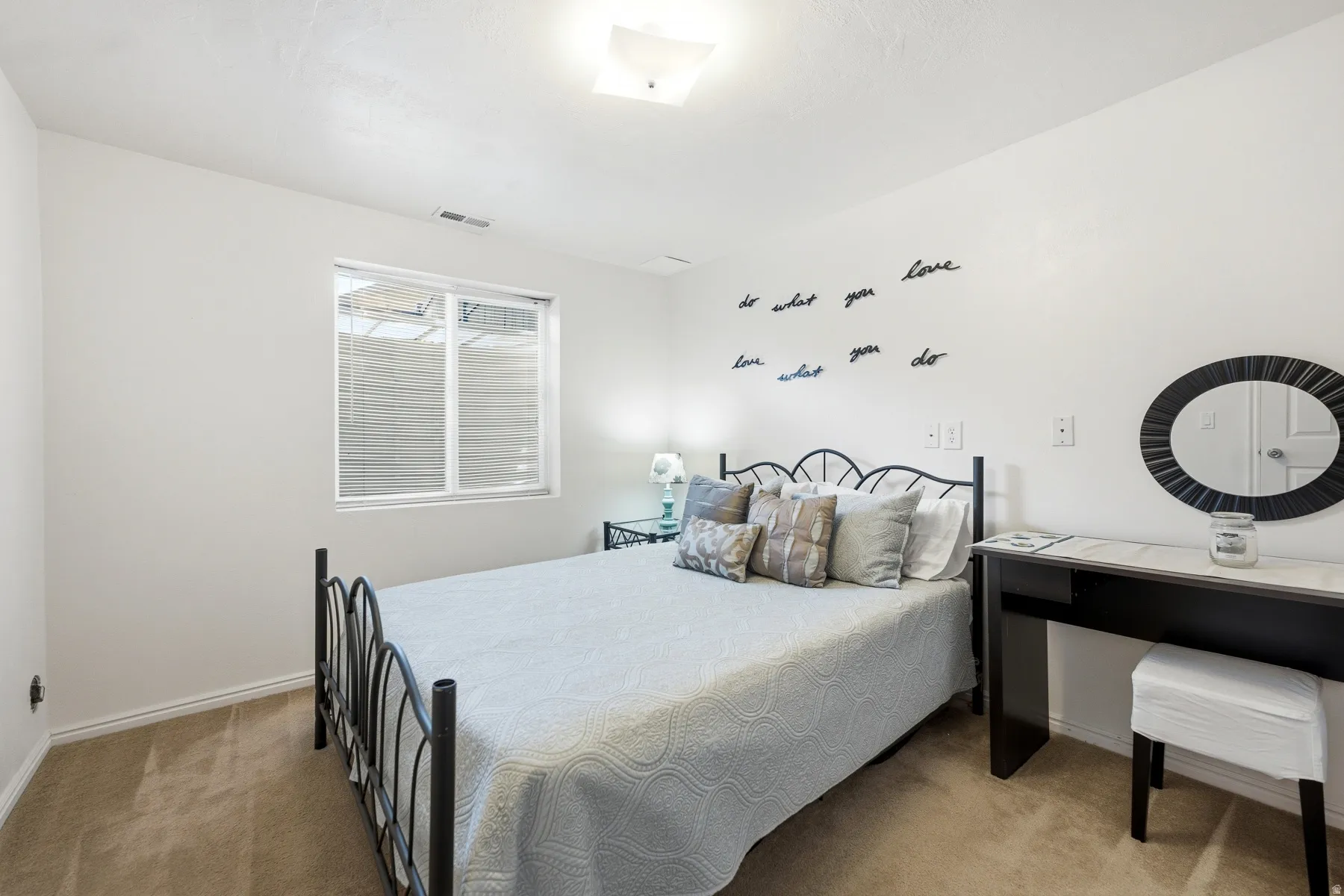 Bedroom featuring light-colored walls and carpet flooring
