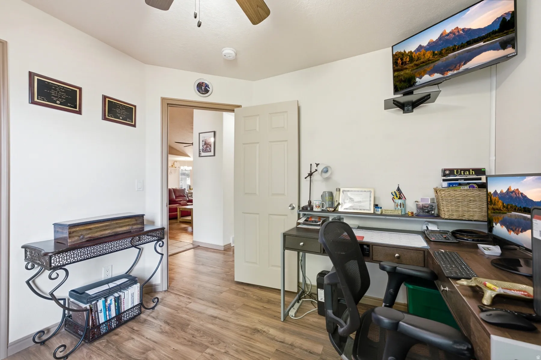 Wood-finish flooring throughout, with a ceiling fan and recessed lighting