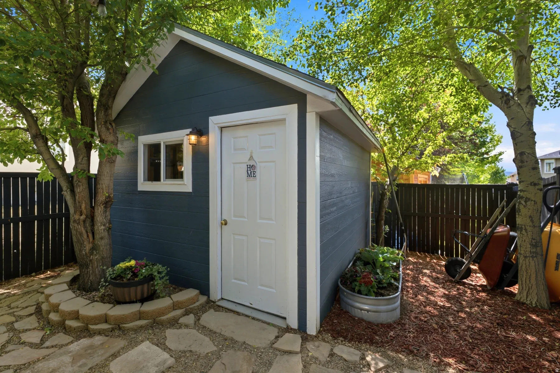 SHE SHED, detached storage shed with blue siding and white trim