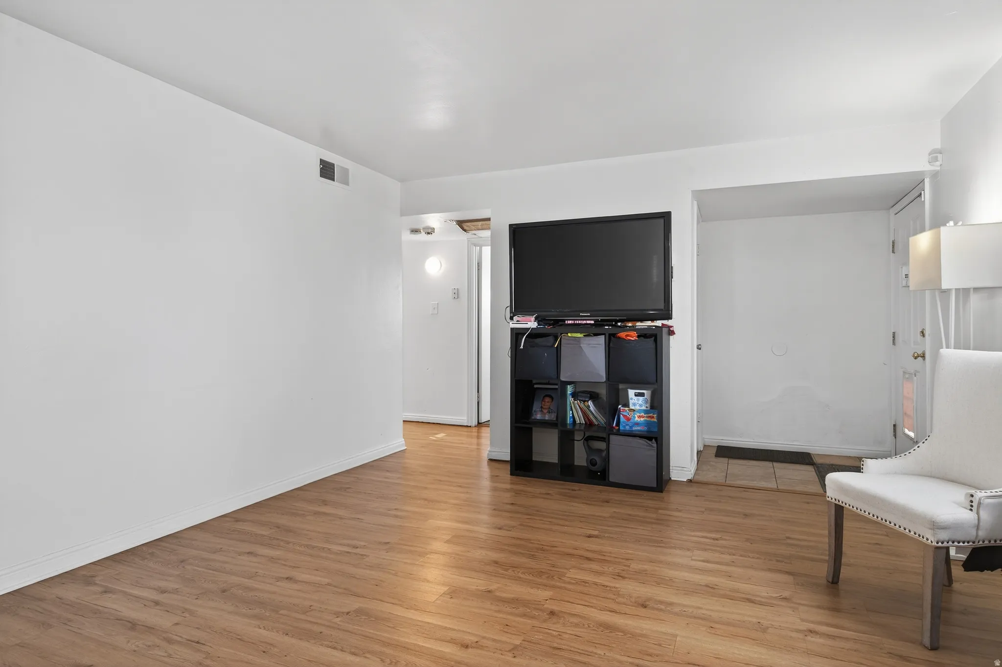 Bright interior space featuring wood-finish flooring, white walls, and white trim