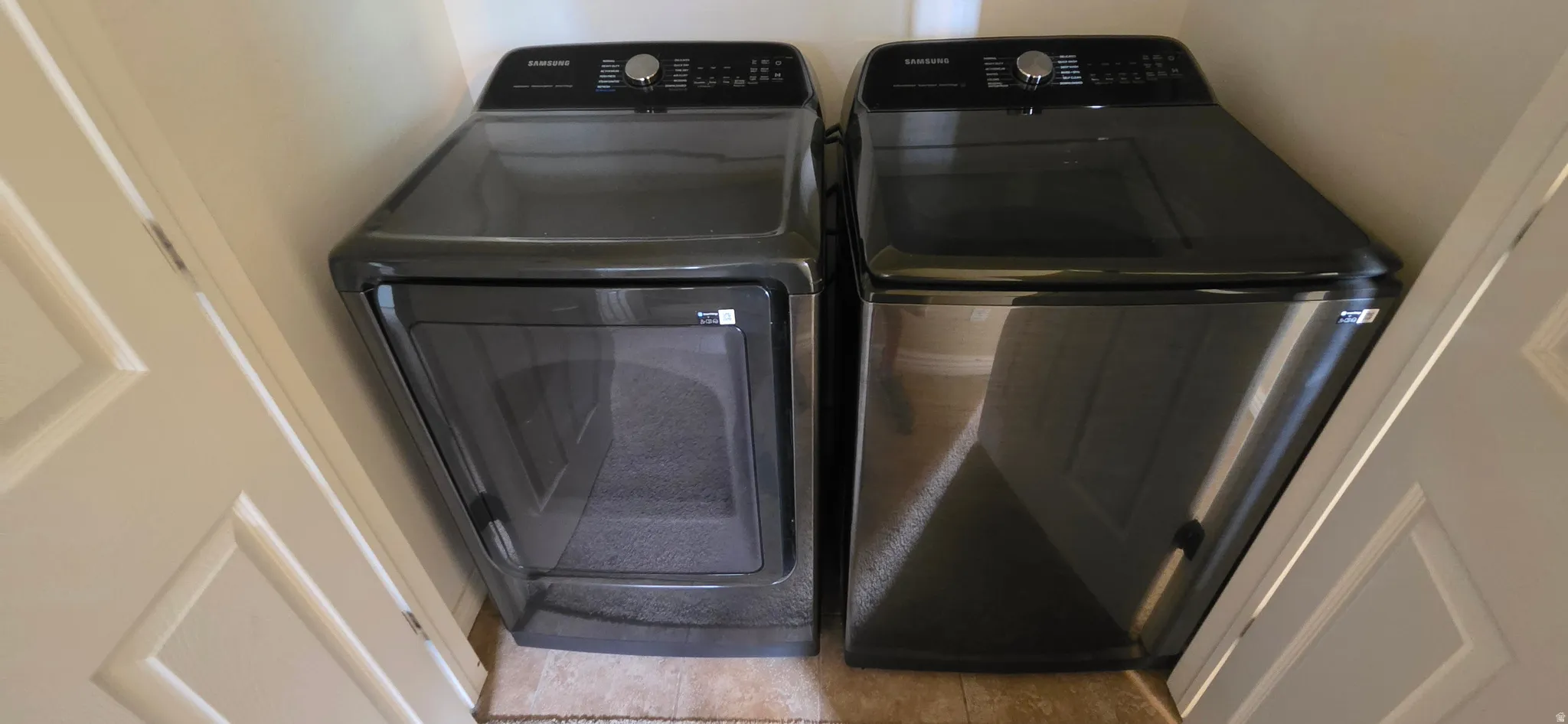 Dedicated laundry area with durable tile flooring
