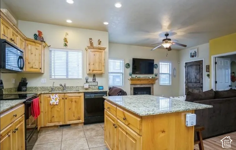 Kitchen featuring recessed lighting, a stone-finish countertop, wood-finish cabinetry, and a tile backsplash