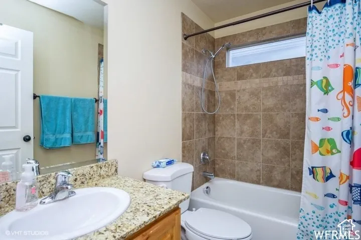 Bathroom featuring a tiled shower surround, integrated bathtub, and a window above the shower