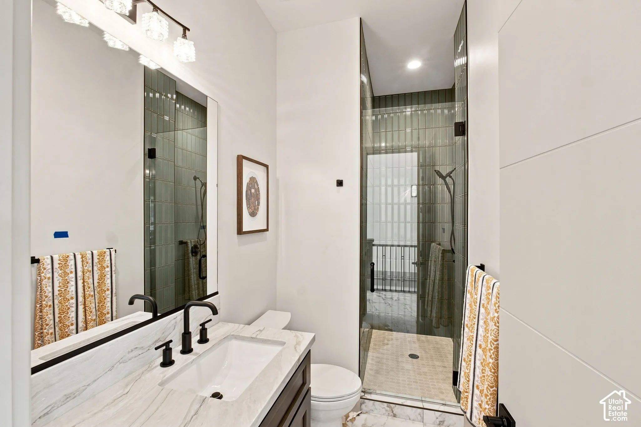 Vanity with stone countertop, undermount sink, and matte black fixtures
