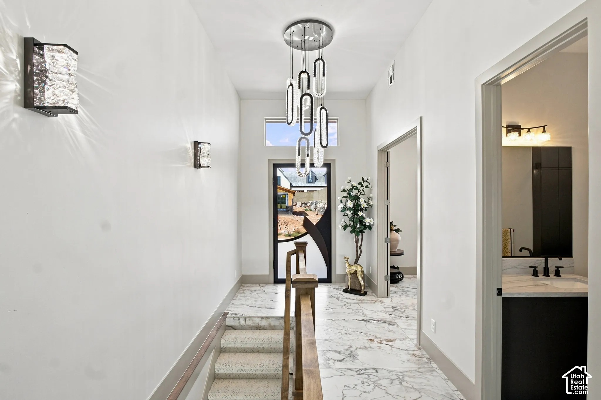 Foyer featuring a contemporary chandelier, recessed lighting, and stone-finish flooring