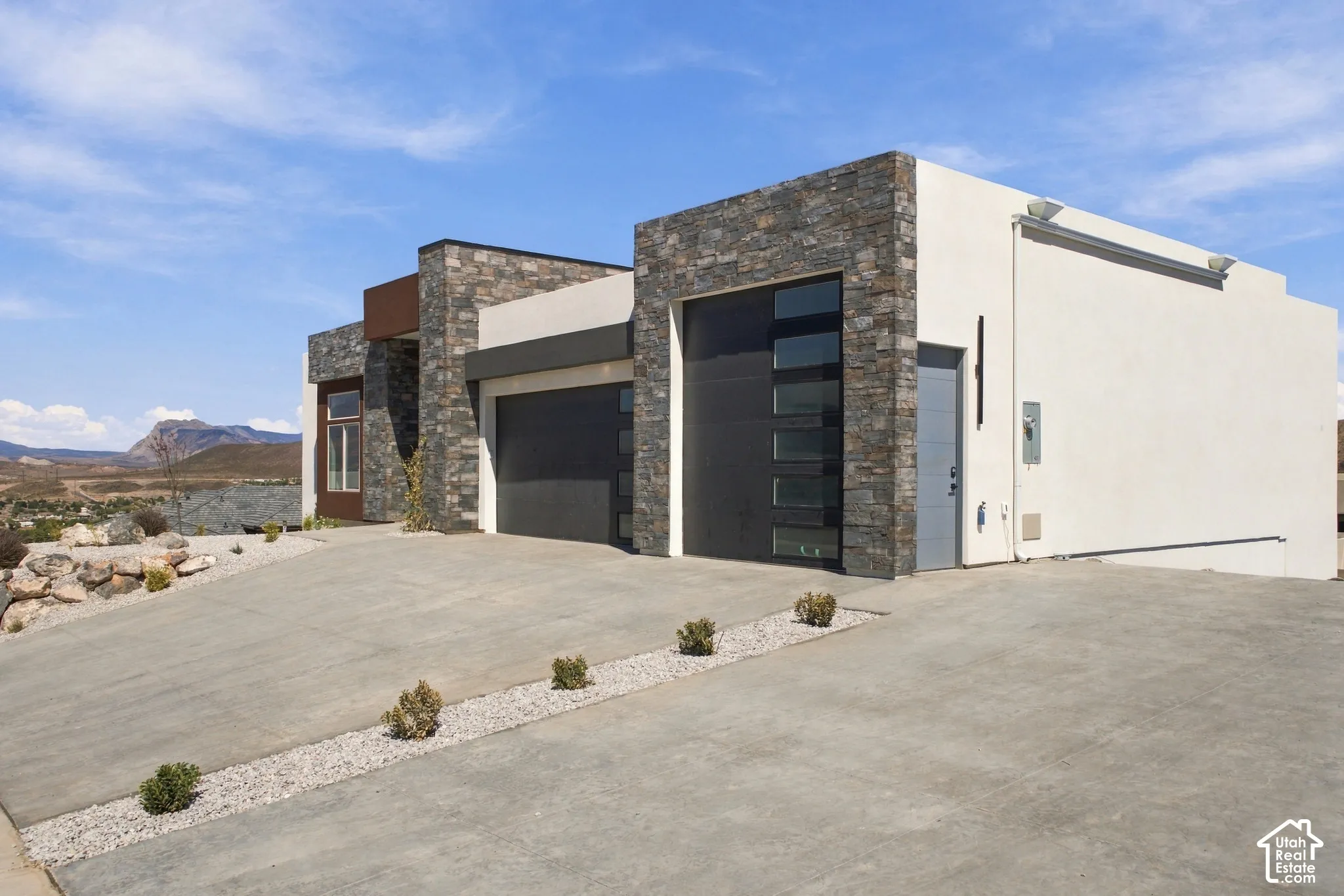 Modern exterior featuring stone veneer and stucco finishes