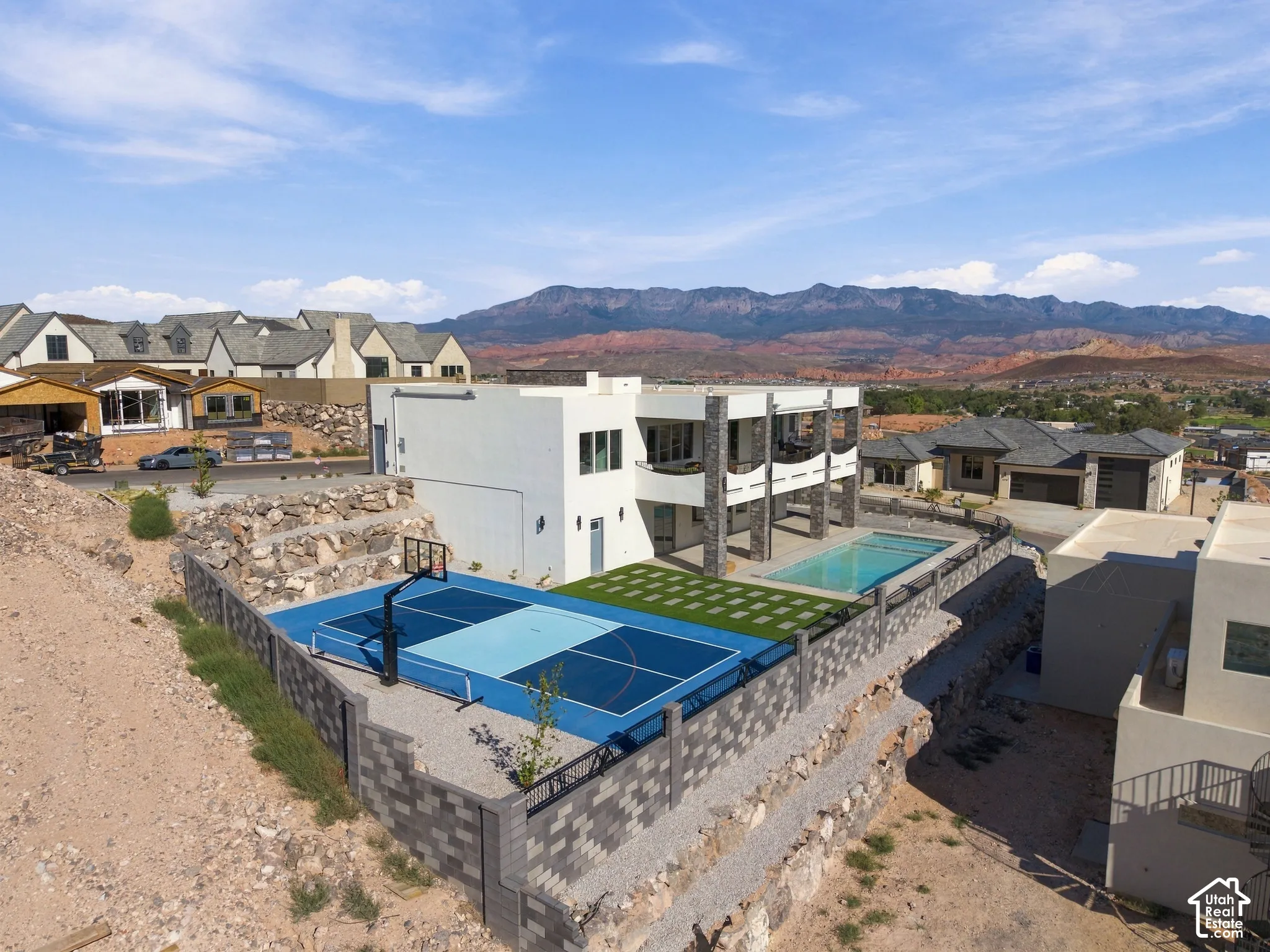 Modern exterior with multiple balconies, a full-size sports court, and a swimming pool