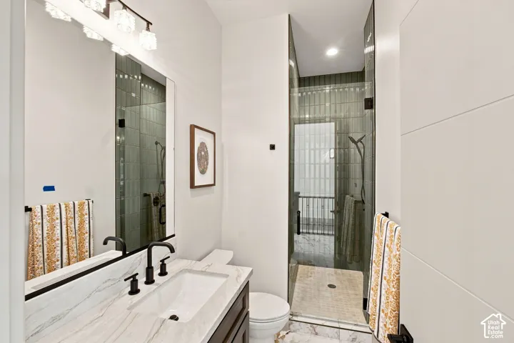 Vanity with stone countertop, undermount sink, and matte black fixtures
