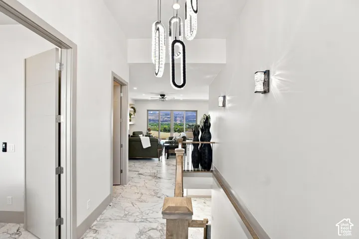 Marble-look tile flooring leading to a living area with large windows