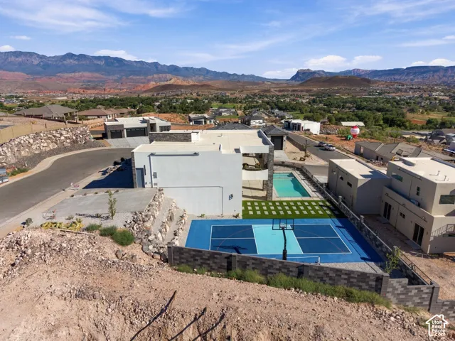 Contemporary architecture with a flat roof, an outdoor swimming pool, and a multi-sport court