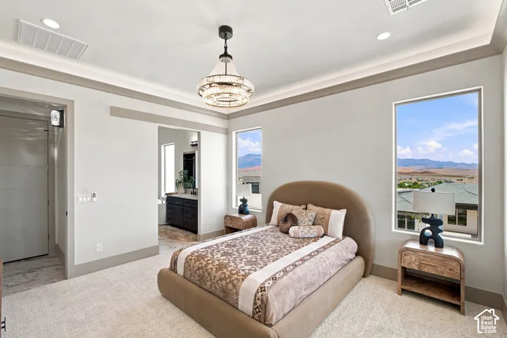 Carpeted flooring complemented by a decorative chandelier