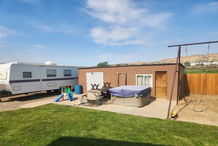 Outbuilding shop and storage with full power and on cement slab with extended patio area.