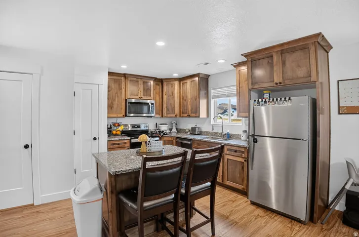 Kitchen featuring wood-finish flooring and recessed lighting
