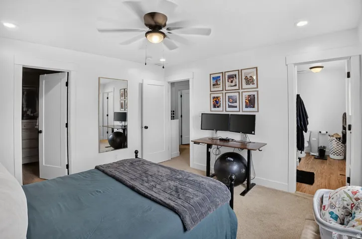 Bright interior space featuring white walls and a ceiling fan with integrated lighting