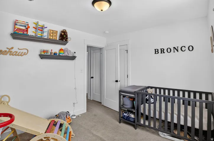 Bedroom featuring light gray carpet, white walls, and a semi-flush mount ceiling light