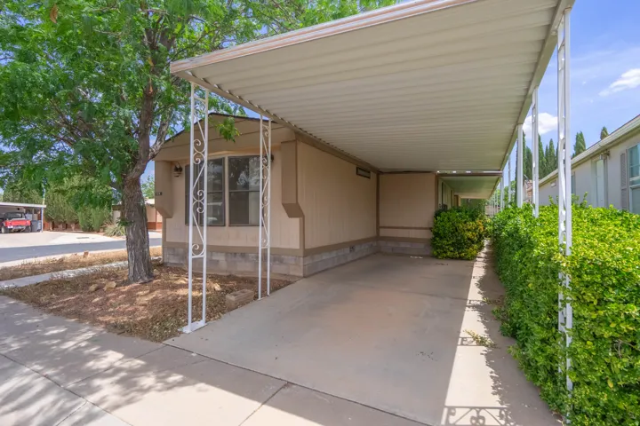 Covered carport with decorative metal supports