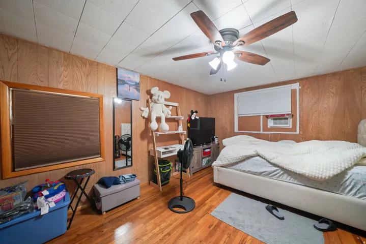Wood-finish flooring complemented by wood paneling on the walls