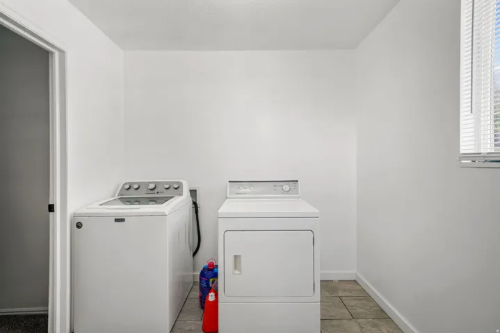 Dedicated laundry area featuring a white washing machine and dryer