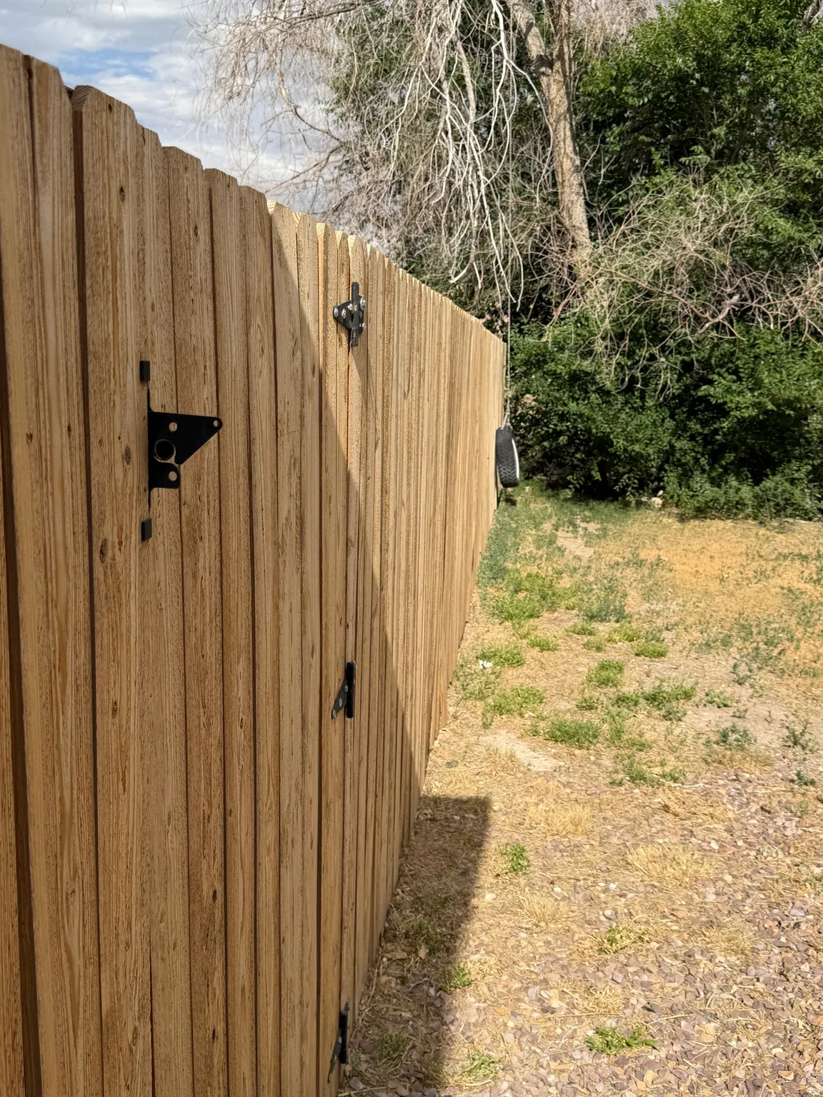 Wood privacy fencing with black hardware