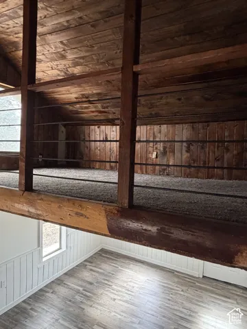 Vaulted ceiling interior featuring exposed wood beams and wood planking