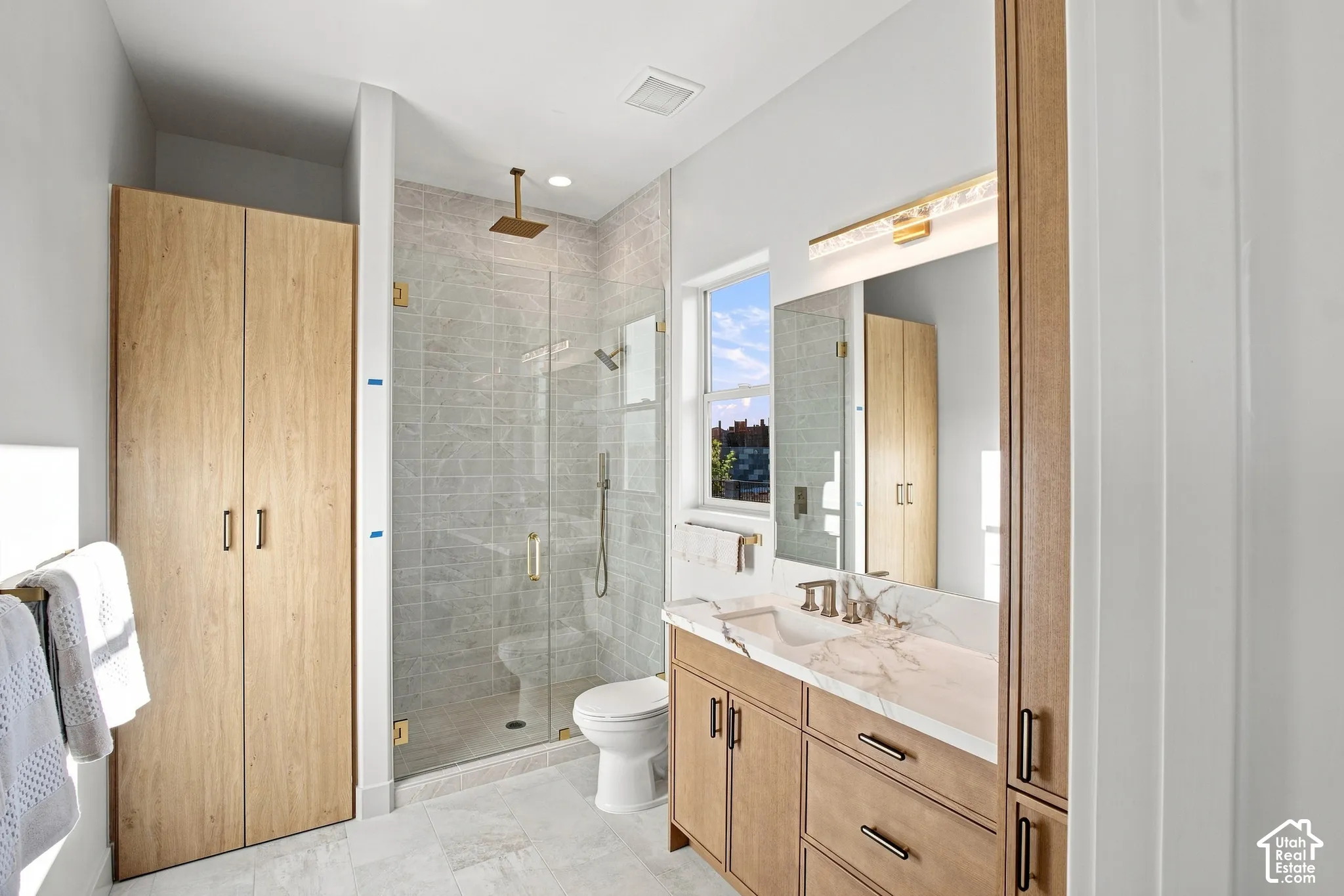 Floating wood-finish vanity with an integrated rectangular sink and stone countertop
