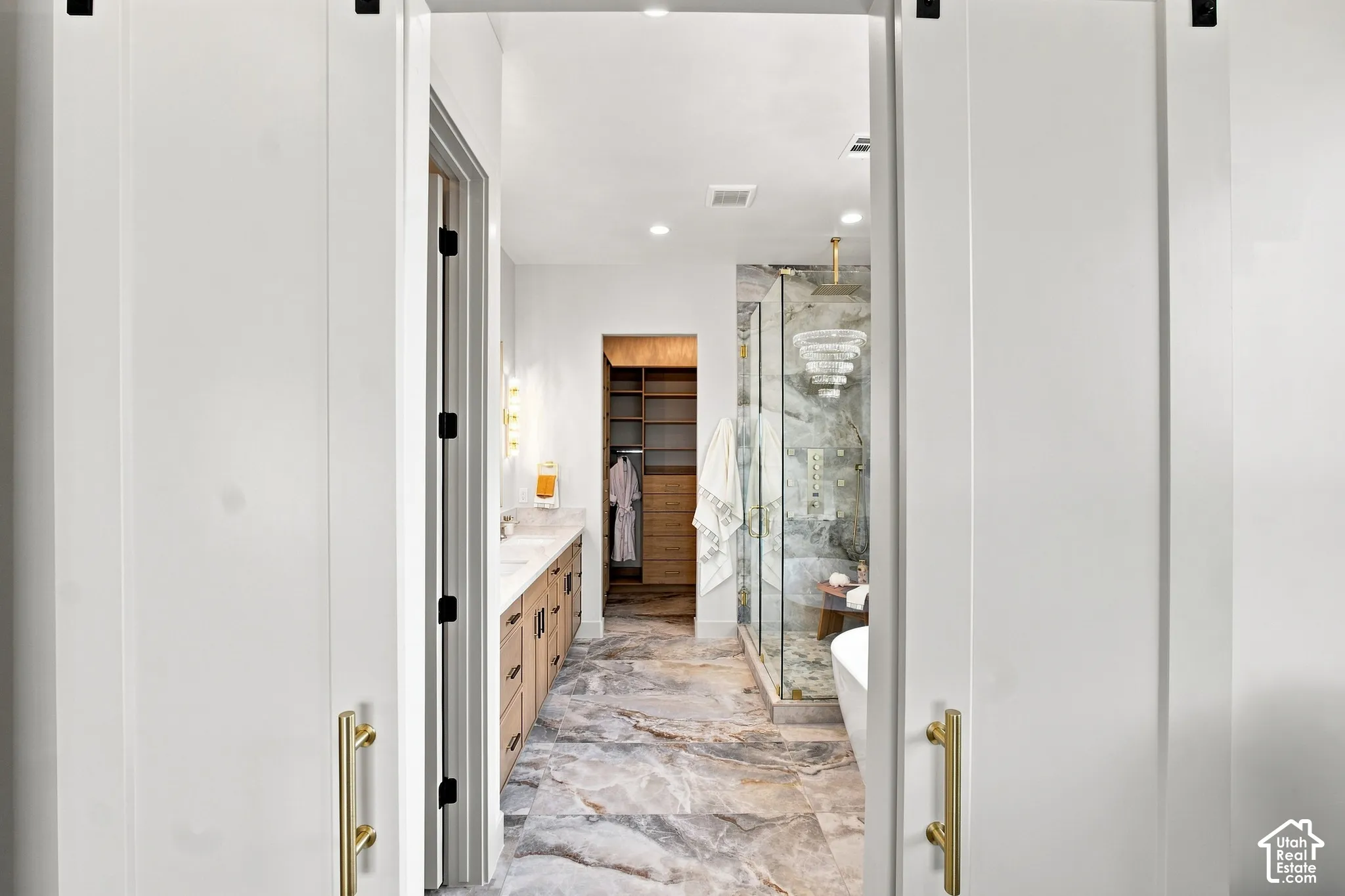 Wide-plank white barn doors with brass hardware