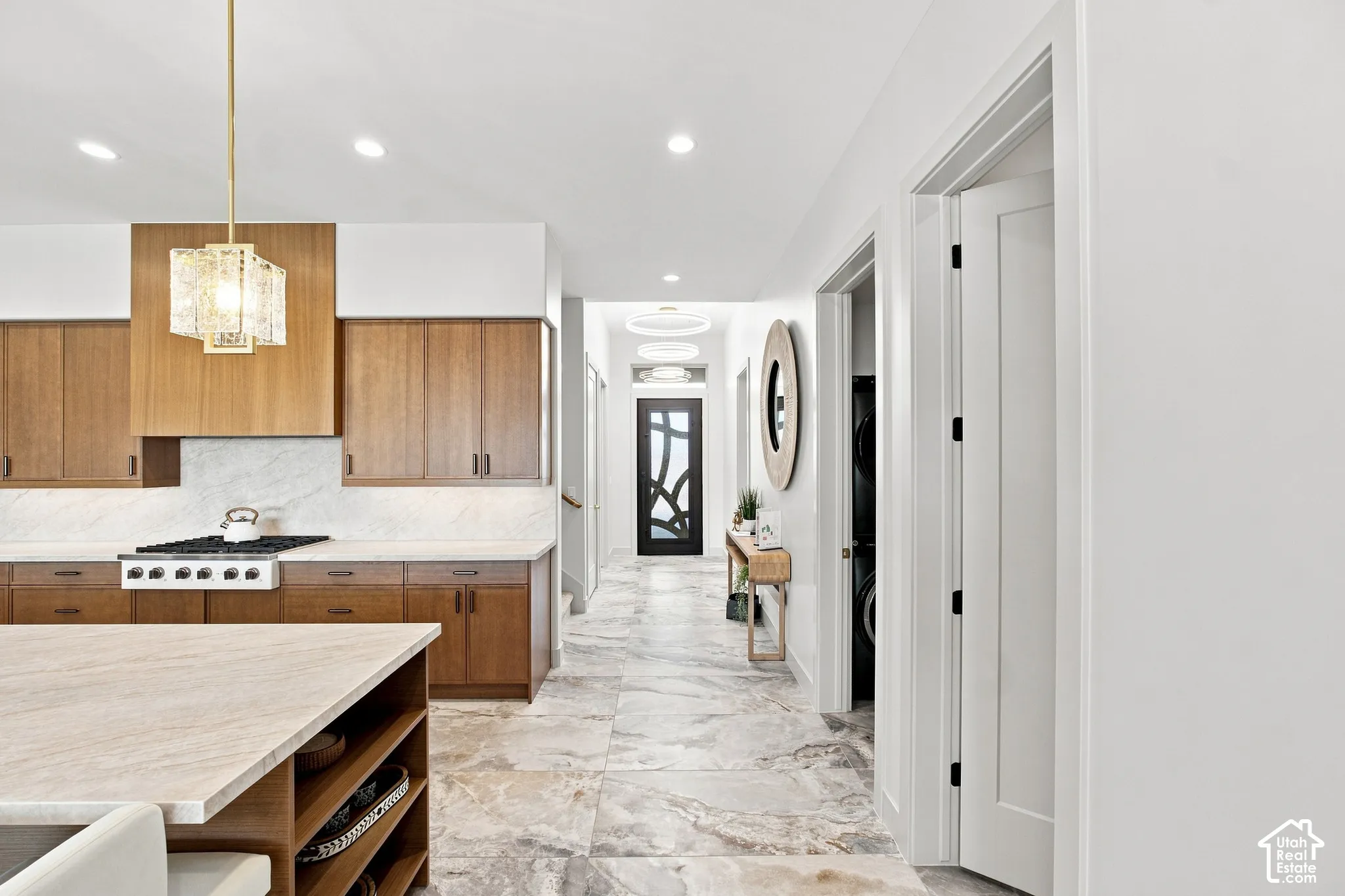 Kitchen featuring wood cabinetry, light-toned countertops, and a gas range