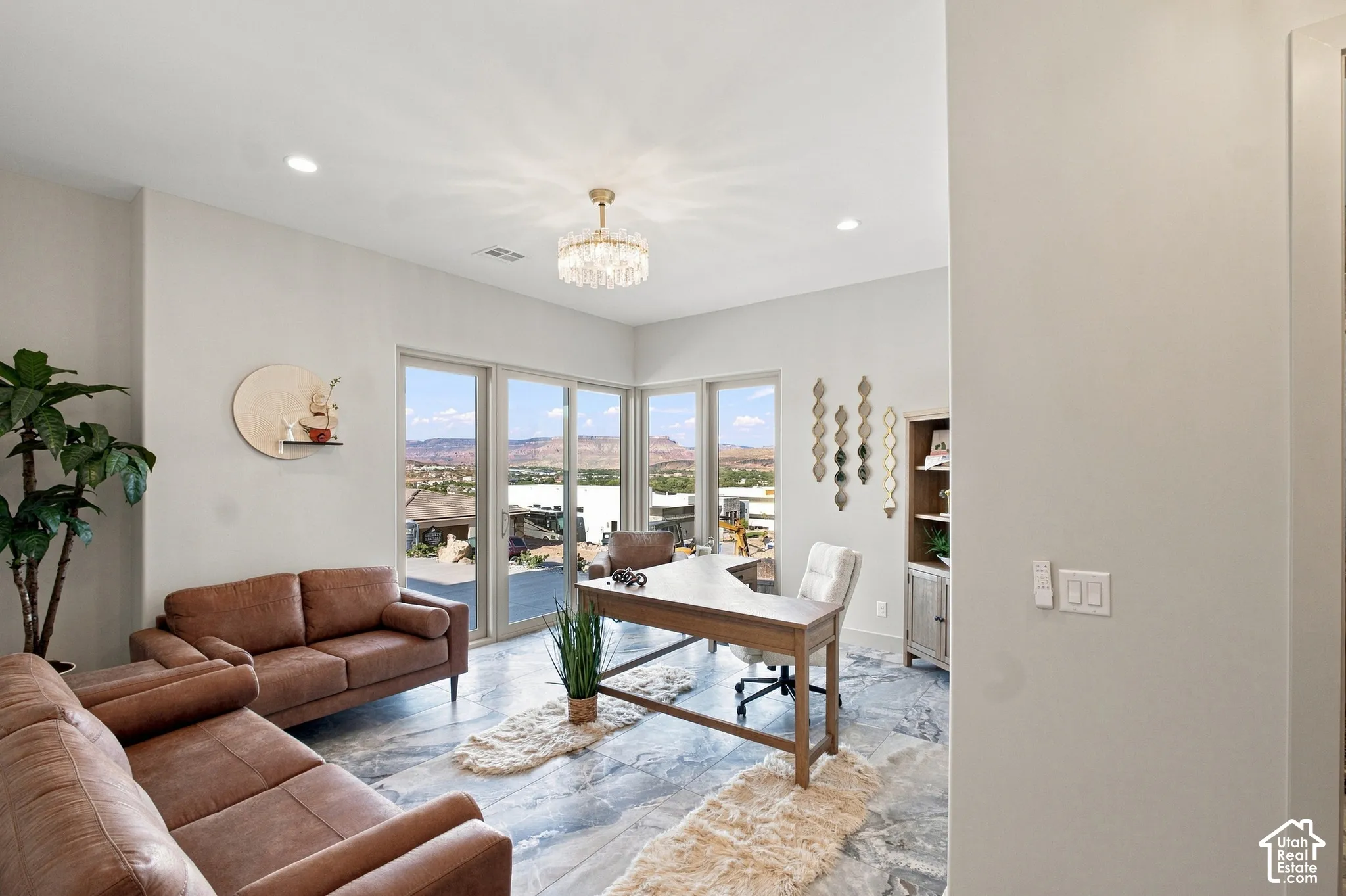 Recessed lighting, large format tile flooring, built-in shelving, chandelier, and a built-in desk