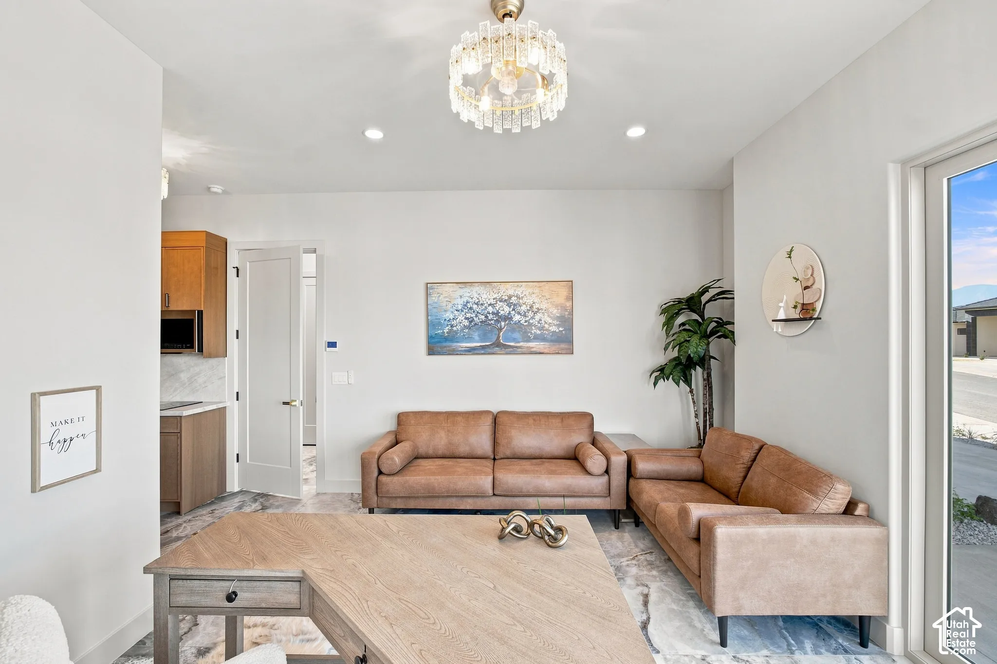 Recessed lighting, contemporary chandelier, wood-finish flooring, white walls, and a glass-paneled exterior door