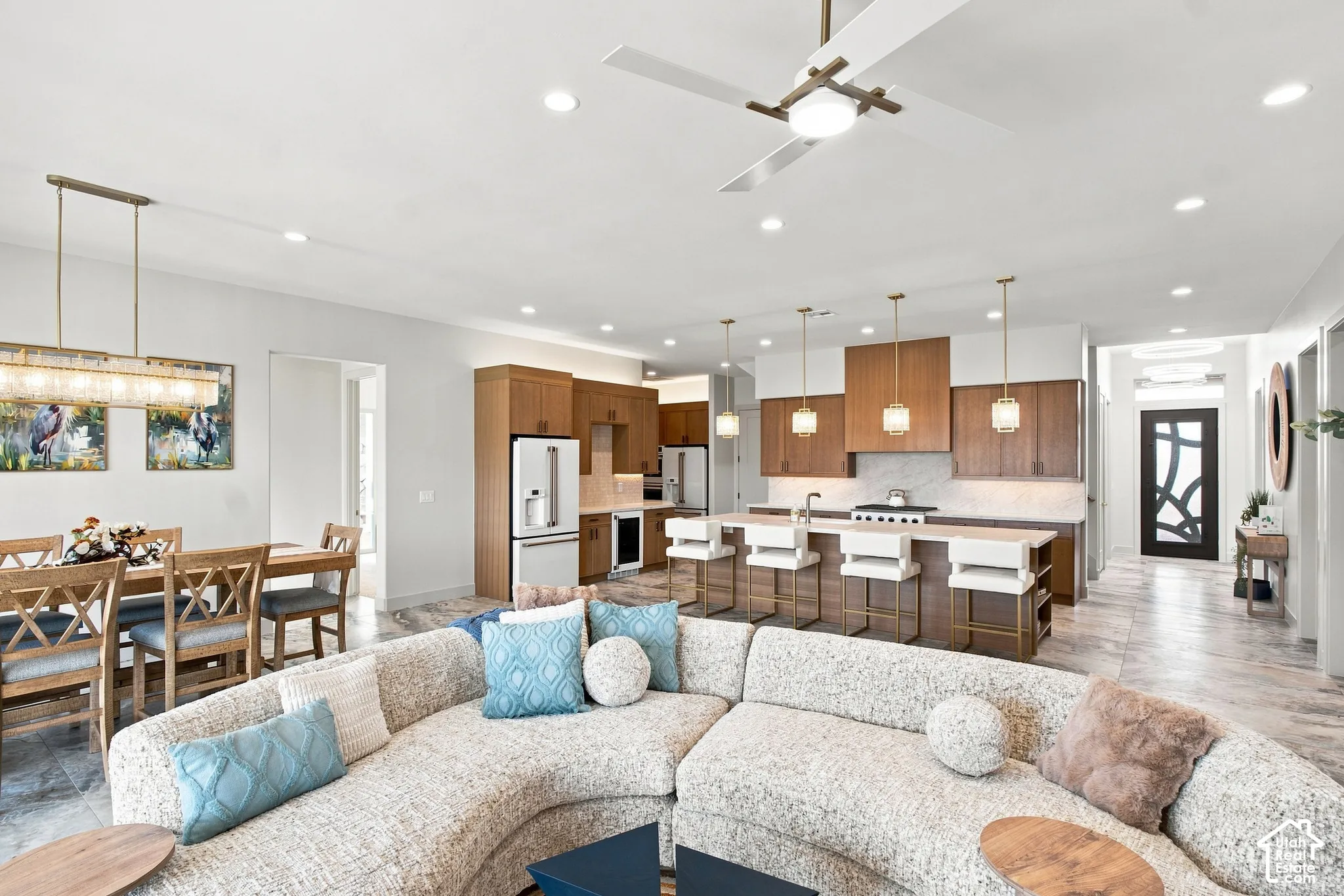 Open-concept living space featuring a modern kitchen, dining area, and living room