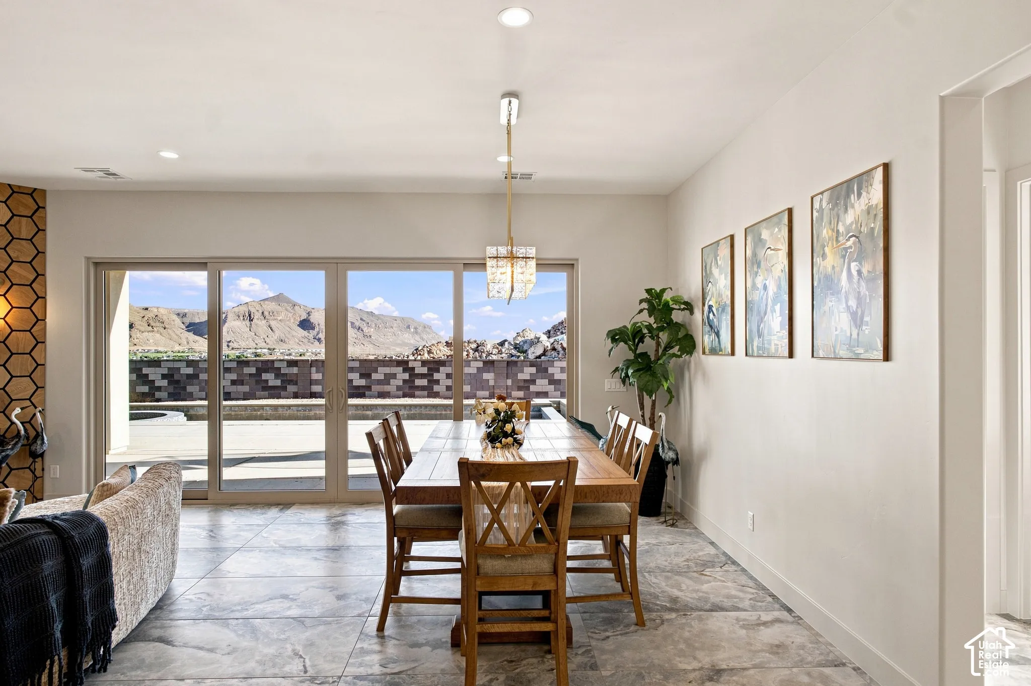 Expansive sliding glass doors, recessed lighting, and large format floor tiling