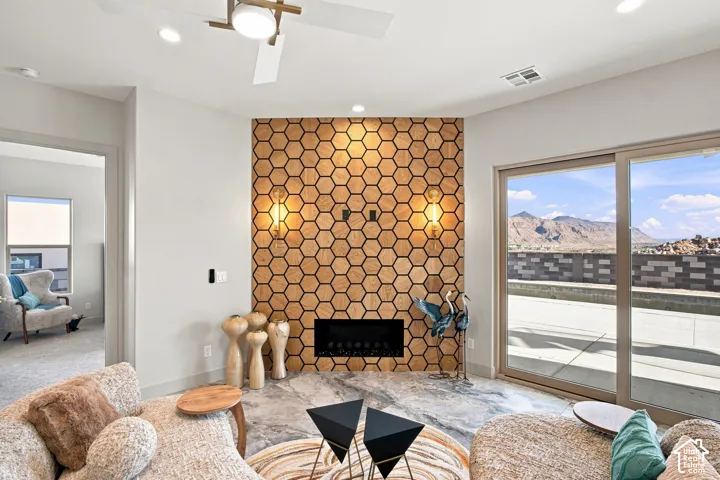 Accent wall featuring geometric wood-finish tiles, built-in fireplace, and integrated sconce lighting