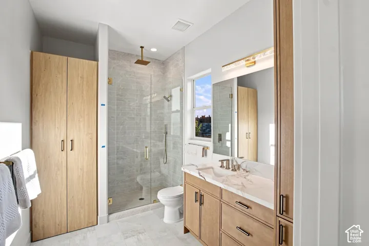 Floating wood-finish vanity with an integrated rectangular sink and stone countertop