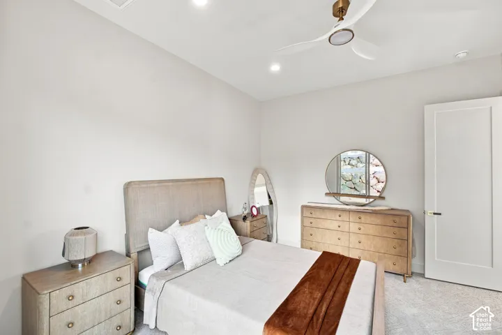 Recessed lighting, ceiling fan with brushed gold accents, paneled interior door, light-colored carpeting, and light wall finishes