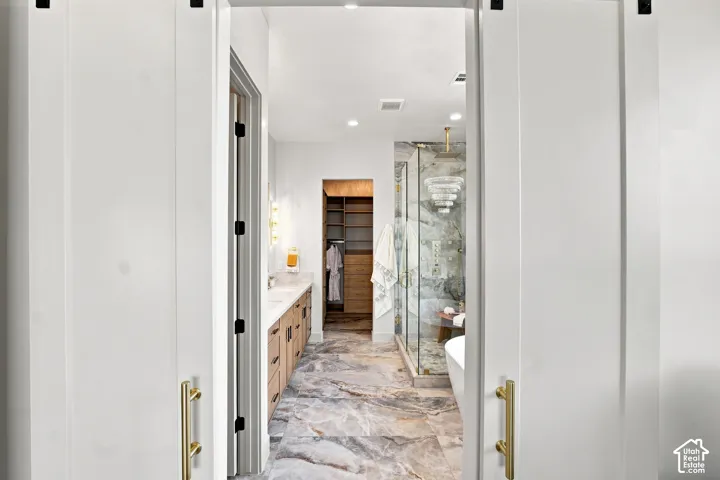 Wide-plank white barn doors with brass hardware