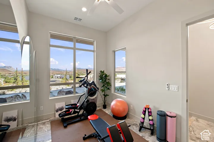 Tall ceilings, recessed lighting, ceiling fan, and large windows with desert scenery