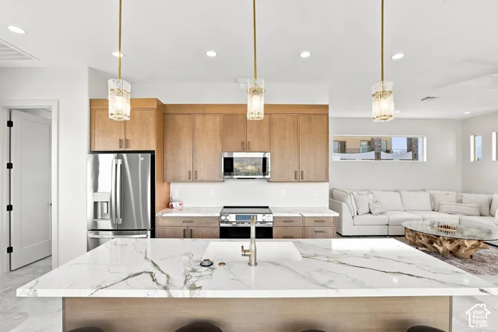 Expansive kitchen island with a waterfall edge and integrated sink