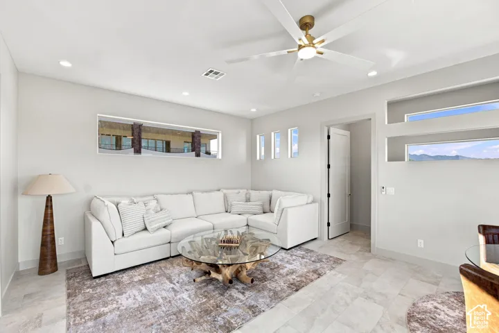 Recessed lighting, ceiling fan with brushed gold accents, rectangular transom windows, tile flooring, built-in wall niche with horizontal windows