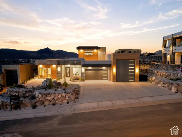 Modern architectural facade with stone accents, wood-finish paneling, and a multi-level design