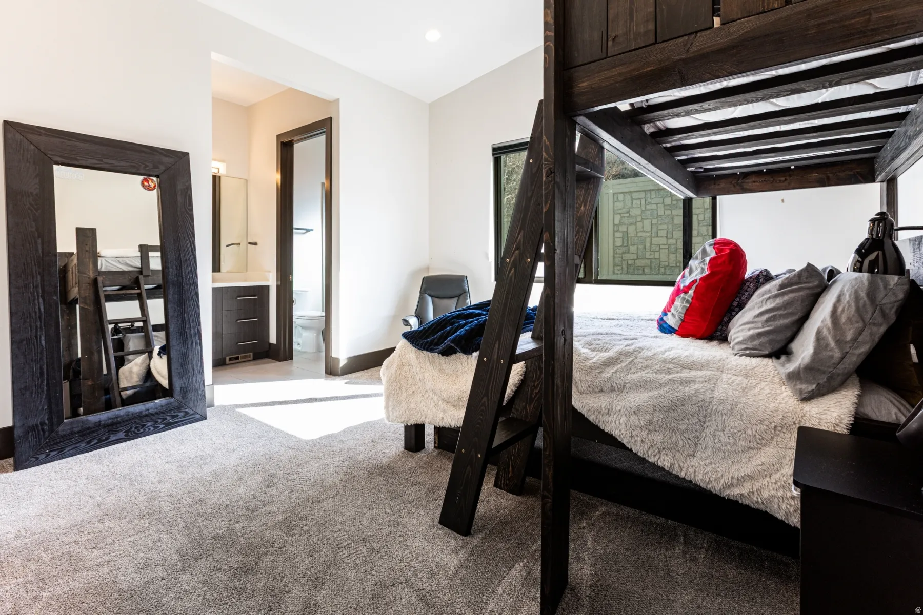 Bedroom 2 featuring built-in bunk beds with dark wood-finish framing, light gray carpeting, and white walls