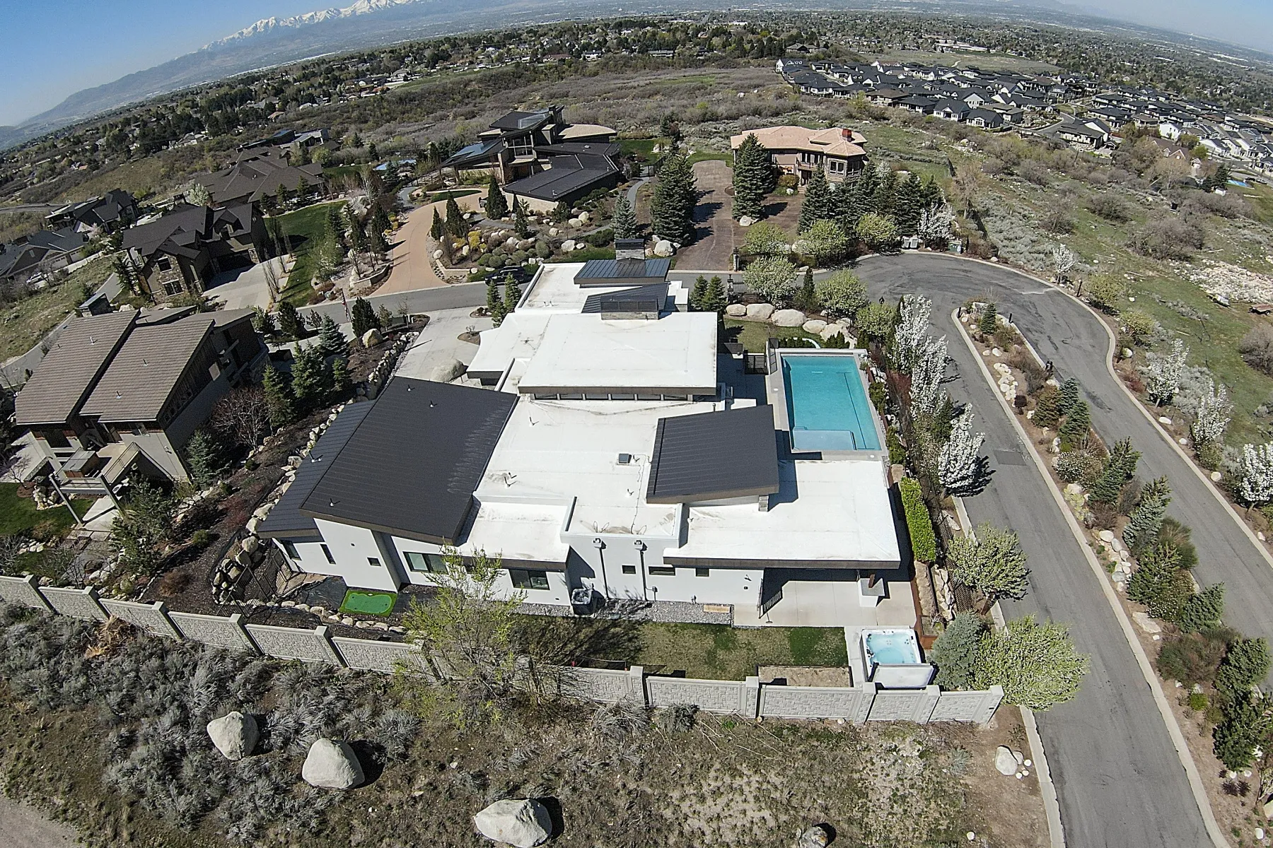 Modern architectural residence featuring a flat roofline and a rectangular swimming pool