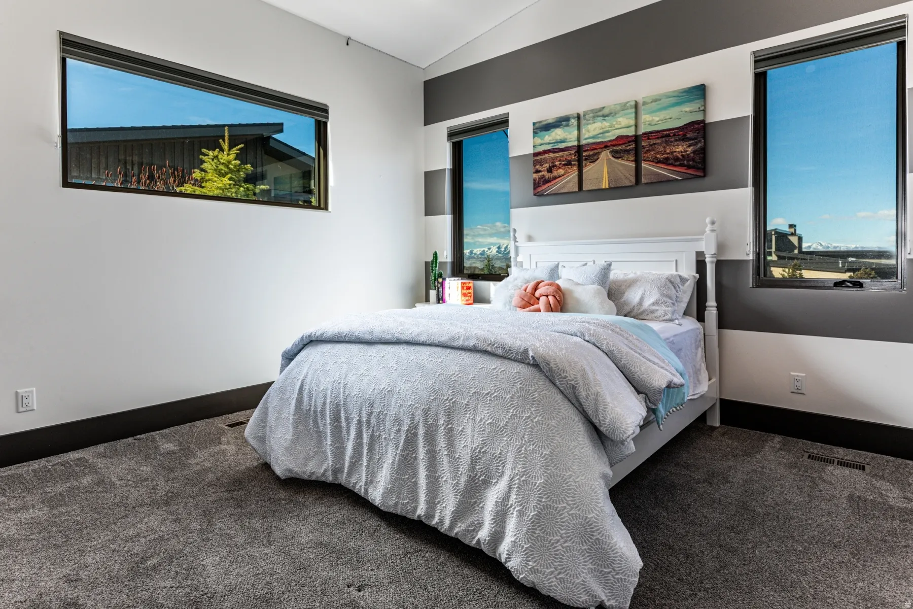 bedroom 5 featuring gray carpet flooring and contemporary wall paneling