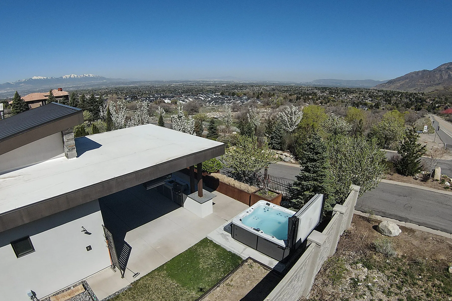 Outdoor patio with a built-in spa, concrete surfacing, and integrated planters