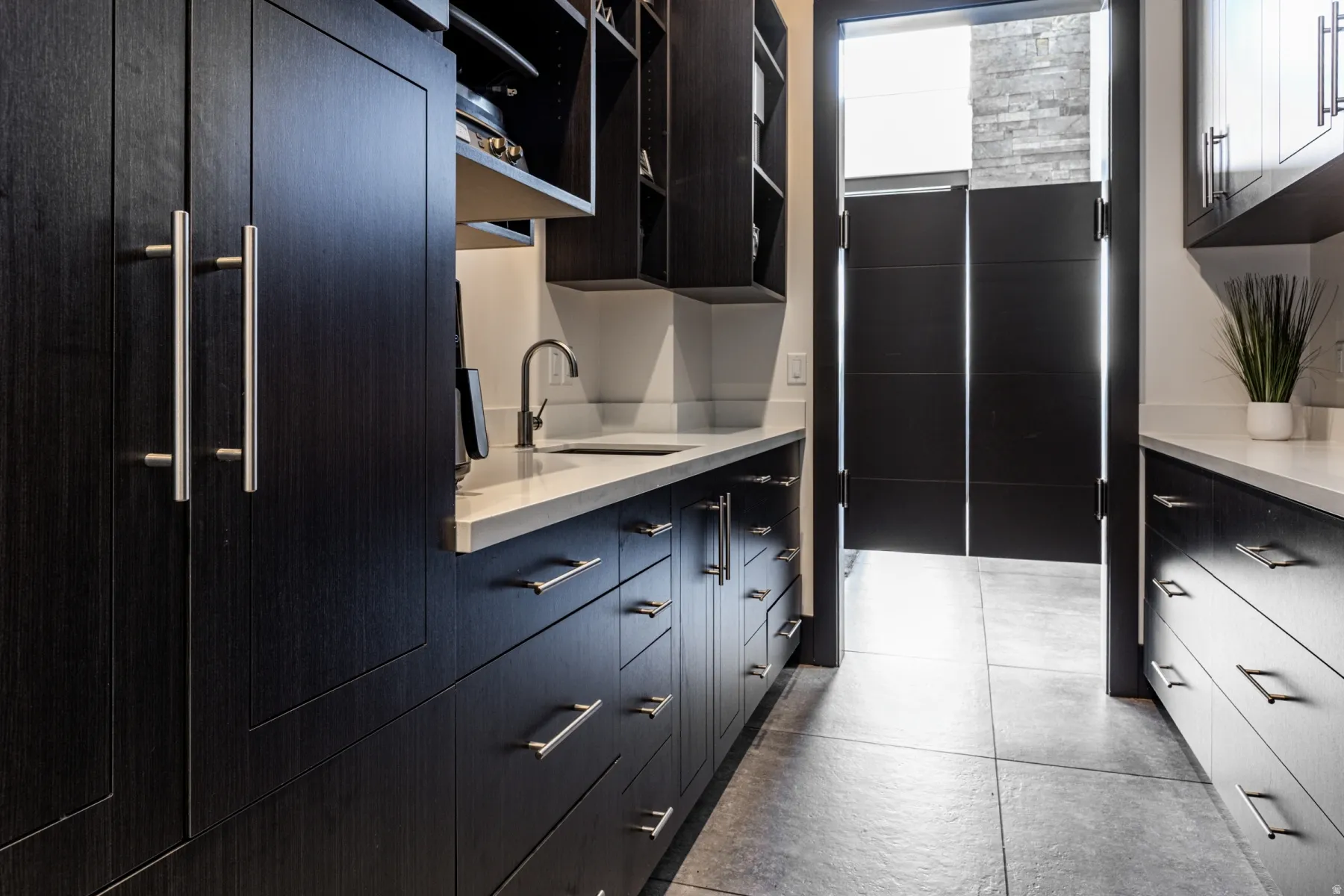 Butler's Pantry Custom dark wood-finish cabinetry featuring brushed nickel hardware
