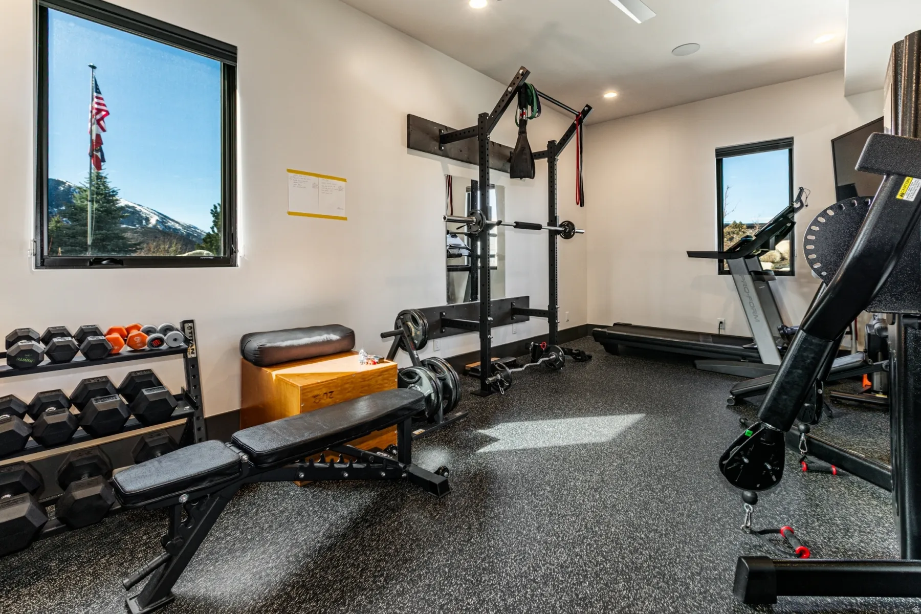 Dedicated fitness room featuring specialized rubber flooring, recessed lighting, and white walls