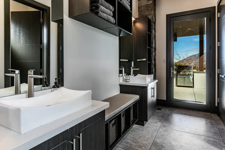 Bathroom 7 - Pool bathroom. Modern vanity featuring a vessel sink, chrome faucet, and dark wood-finish cabinetry
