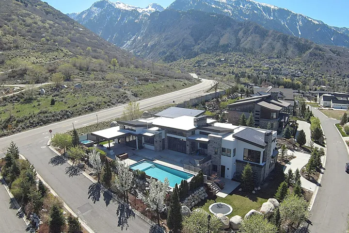 Contemporary architectural design featuring a multi-level structure with stone and stucco exterior finishes