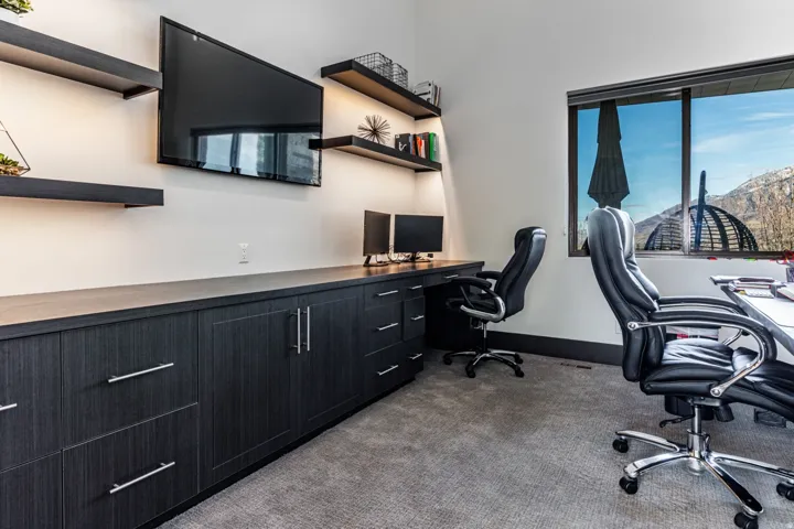 Built-in cabinetry with dark wood-finish, featuring multiple drawers and storage compartments
