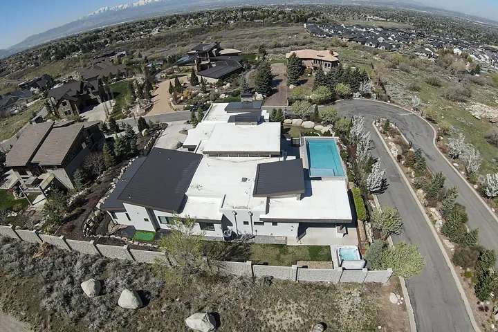 Modern architectural residence featuring a flat roofline and a rectangular swimming pool